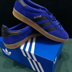 Adidas Gazelle Indoor shoes in the Lucid Blue, Black, and Gold Metallic